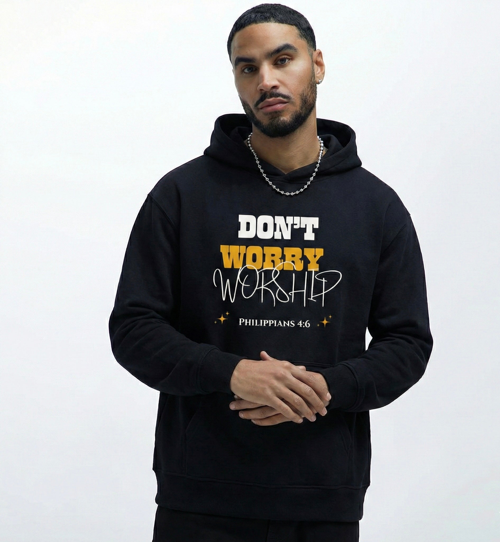 Man wearing a Christian black hoodie with dont worry worship text
