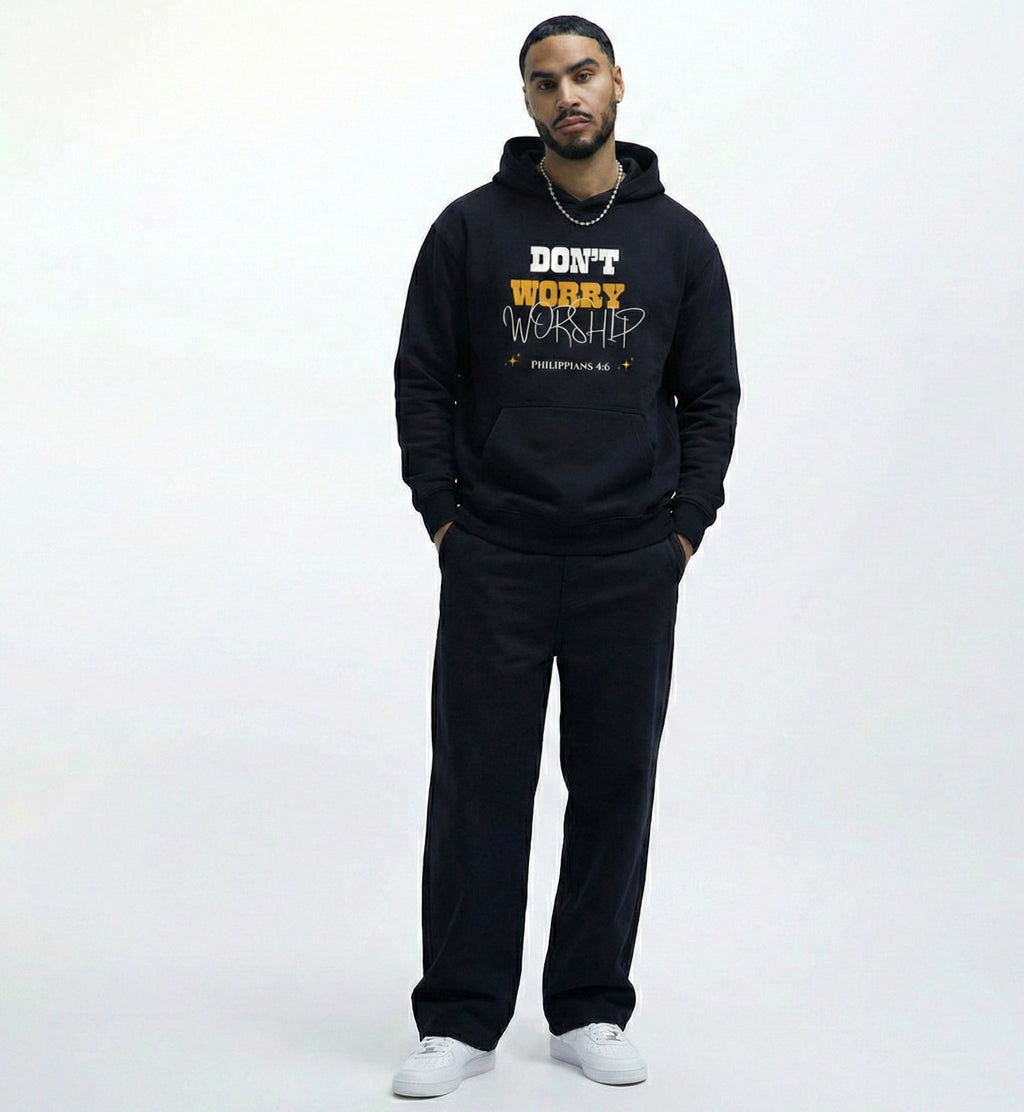 Man wearing a faith based black hoodie with dont worry worship text with philippians 4:6