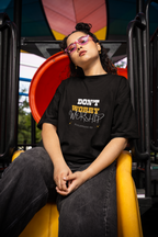 GIRLWEARING premium black Christian t-shirt with 'Don't Worry Worship' logo, streetwear style.